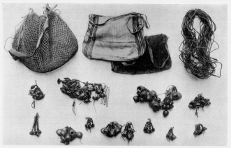 Fig. 23—Ornaments and fabrics of the Machiganga Indians
at Yavero. The nuts are made up into strings, pendants, and heavy
necklaces. To the left of the center is one that contains feathers and
four drumsticks of a bird about the size of a small wild
turkey—probably the so-called turkey inhabiting the eastern mountain
valleys and the adjacent border of the plains, and hunted as an
important source of food. The cord in the upper right-hand corner is
used most commonly for heel supports in climbing trees. The openwork
sack is convenient for carrying game, fish, and fruit; the finely woven
sacks are used for carrying red ochre for ornamenting or daubing faces
and arms. They are also used for carrying corn, trinkets, and game.