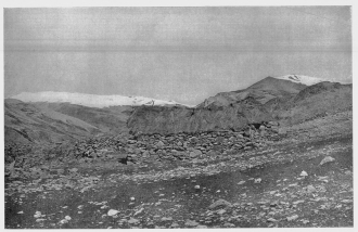 Fig. 24—This stone hut, grass-thatched, is the highest
permanent habitation in Peru, and is believed to be the highest in the
world. Altitude of 17,100 feet (5,210 m.) determined by instrumental
survey. The general geographic relationships of the region in which the
hut is situated are shown in Fig. 25. For location see the topographic
map, Fig. 204.