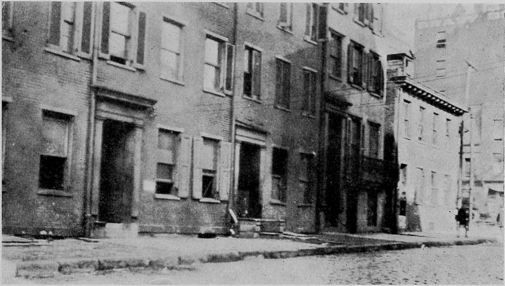 A Row of Dilapidated Old Dwellings in the Downtown
Section Used as Rooming Houses for Migrants.